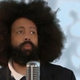Illustration for article titled Reggie Watts made a shot-for-shot Rick Astley remake to RickRoll you with